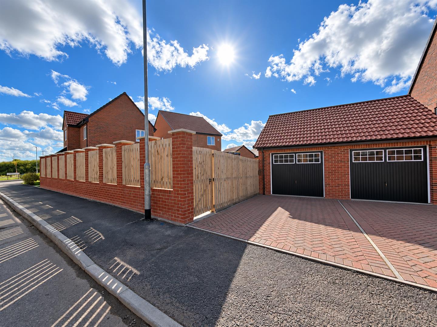 Sunlit Suburban Garage and Fence.png